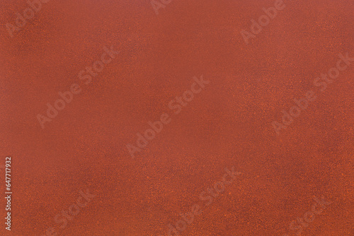 Painted surface of red-brown color with visible texture
