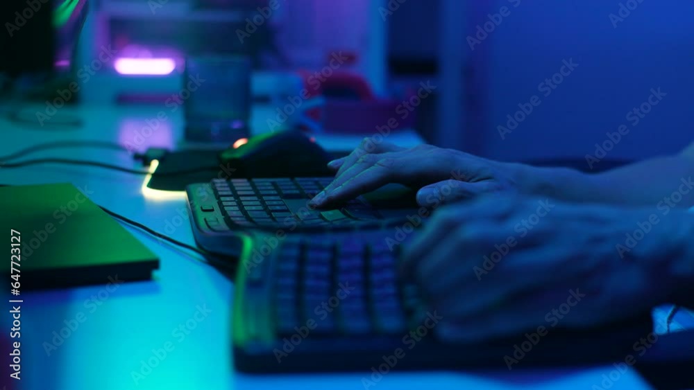 Close-up hands of unrecognizable gamer male typing on keyboard, playing video game. Male hands pushing buttons on computer keyboard. Programmer or hacker working in networks, cyberspace, slow motion.