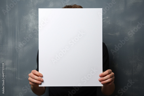 A man is holding a white blank mockup on blue background