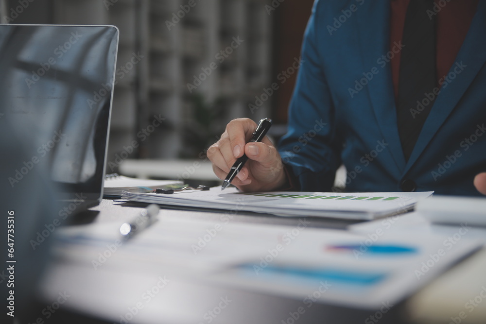 Obraz premium Financial Business team present. Business man hands hold documents with financial statistic stock photo, discussion, and analysis report data the charts and graphs. Finance Financial concept