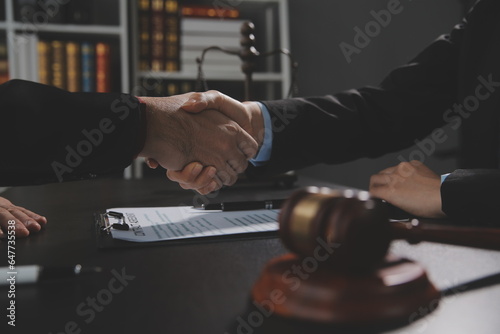 Businessman shaking hands to seal a deal with his partner lawyers or attorneys discussing a contract agreement