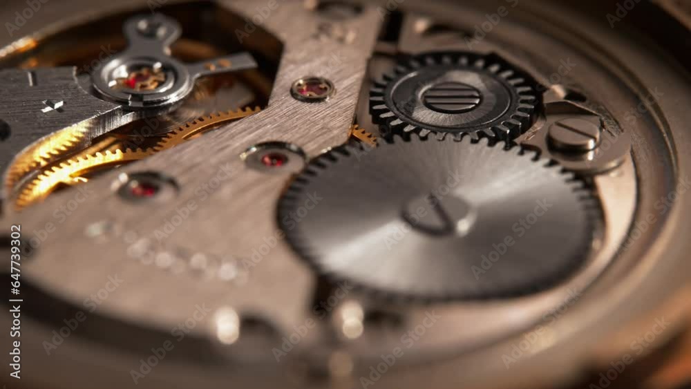 Clockwork Mechanism of Golden Watch with Silver Gears and Red Rubies in