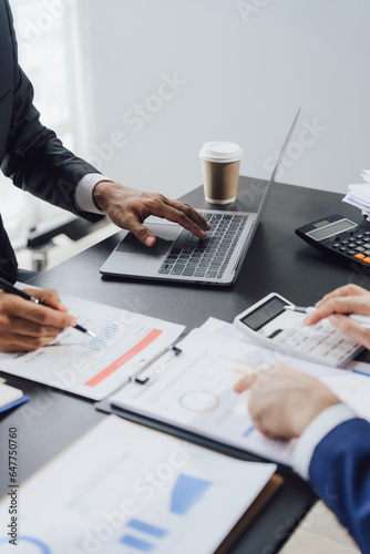 Young colleagues discuss business brainstorming and price charts analyze business people at the desk brilliantly in modern collaborative office teamwork ideas. Calculate personal tax for customers