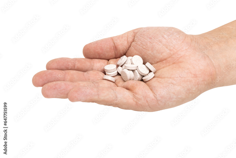 Round therapeutic pills or drugs for treatment in male hand palm isolated on transparent background, medicine and healthcare concept, close-up view