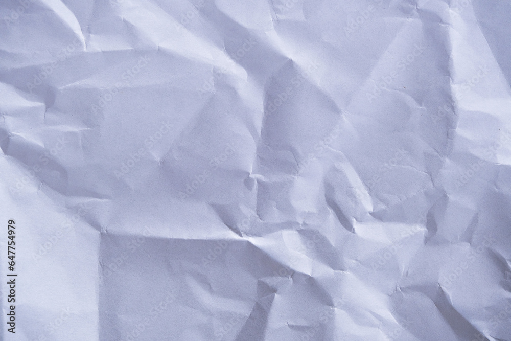White crumpled sheet of paper. Crumpled paper texture. Background made of crumpled white paper.