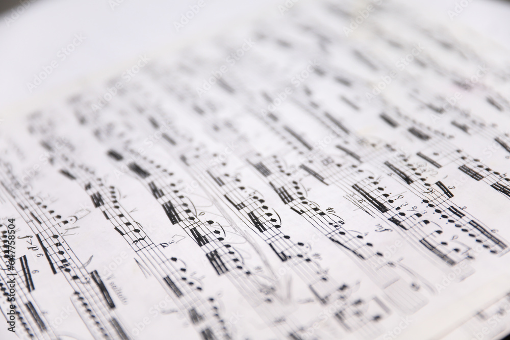 Sheet music notes on paper, artistic composition, musical harmony, creativity