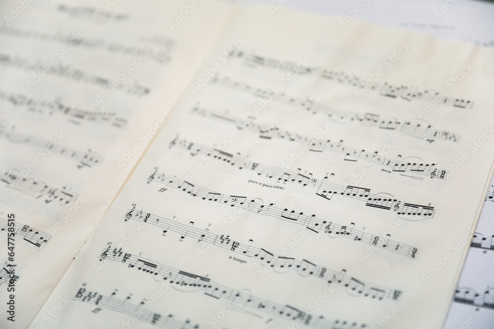 Sheet music notes on paper, artistic composition, musical harmony, creativity Sheet music notes on paper, artistic composition, musical harmony, creativity