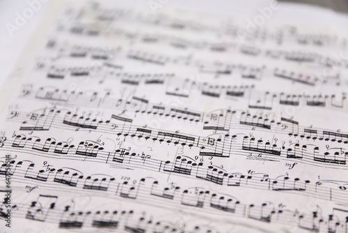 Sheet music notes on paper, artistic composition, musical harmony, creativity