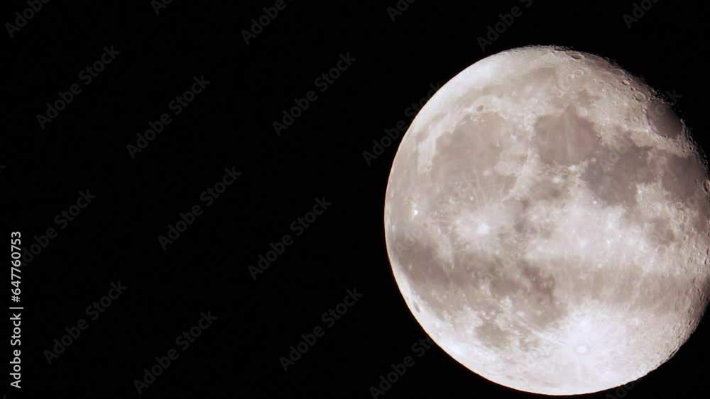 A new mid summer full super moon climbs higher into the dark summer