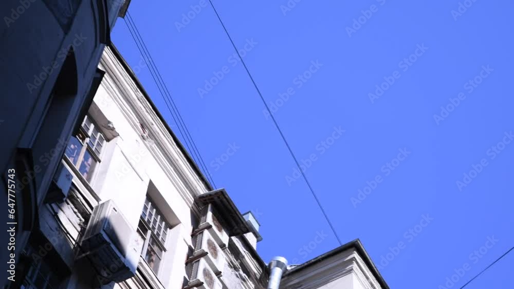 Low angle view of typical well shaped back yard in a sunny summer day in Saint-Petersburg city, Russia. Clear blue sky. Real time handheld video. General architecture theme. Low angle view of typical well shaped back yard in a sunny summer day in Saint-Petersburg city, Russia. Clear blue sky. Real time handheld video. General architecture theme.