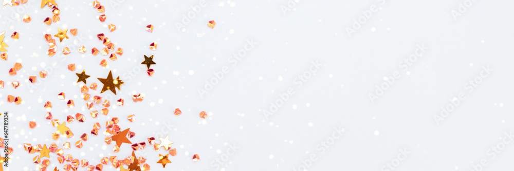Banner with golden stars and crystals confetti on a blue background. Selective focus. Banner with golden stars and crystals confetti on a blue background. Selective focus.