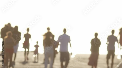 Wallpaper Mural Blurred silhouettes of young people walking on the quay in bright white light Torontodigital.ca