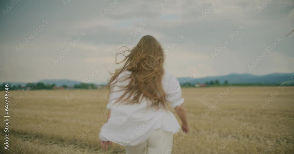Woman With Blond Hair Walking In Field Woman With Blond Hair Walking In Field