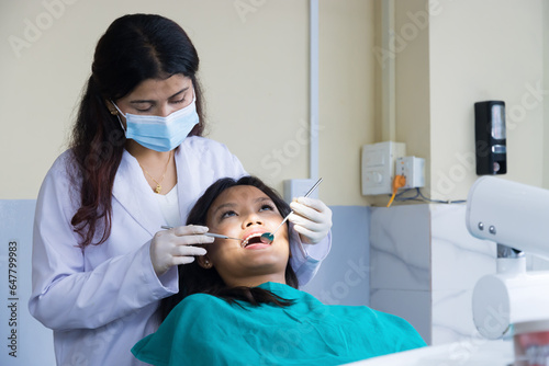 Asian Dentist Checking up on her patient  Female dentist and Female Patient in a Hospital
