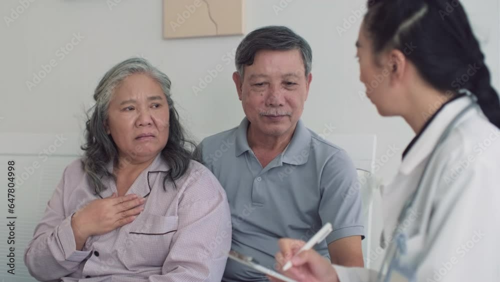 Rack focus of elderly husband talking to doctor about health condition of his sick wife at home Rack focus of elderly husband talking to doctor about health condition of his sick wife at home