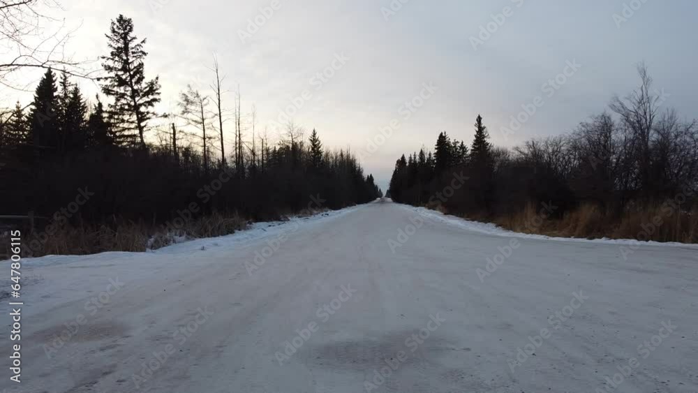 going down a snow covered rural road going down a snow covered rural road