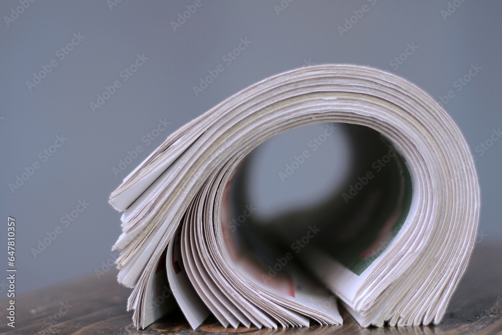 newspaper rolled up and sitting on a table no people stock photo newspaper rolled up and sitting on a table no people stock photo