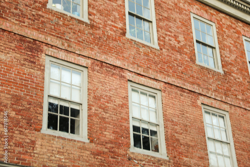 brick building with arched windows, symbolizing stability and growth in the business and mortgage industry, a hub of commerce © Your Hand Please