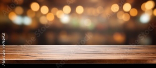 Empty brown wooden table and coffee shop background with bokeh