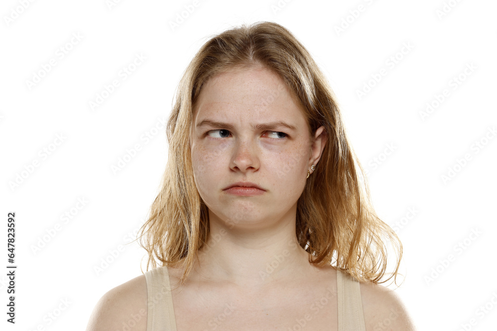 Portrait of young beautiful angry blonde woman with no makeup on white background Portrait of young beautiful angry blonde woman with no makeup on white background