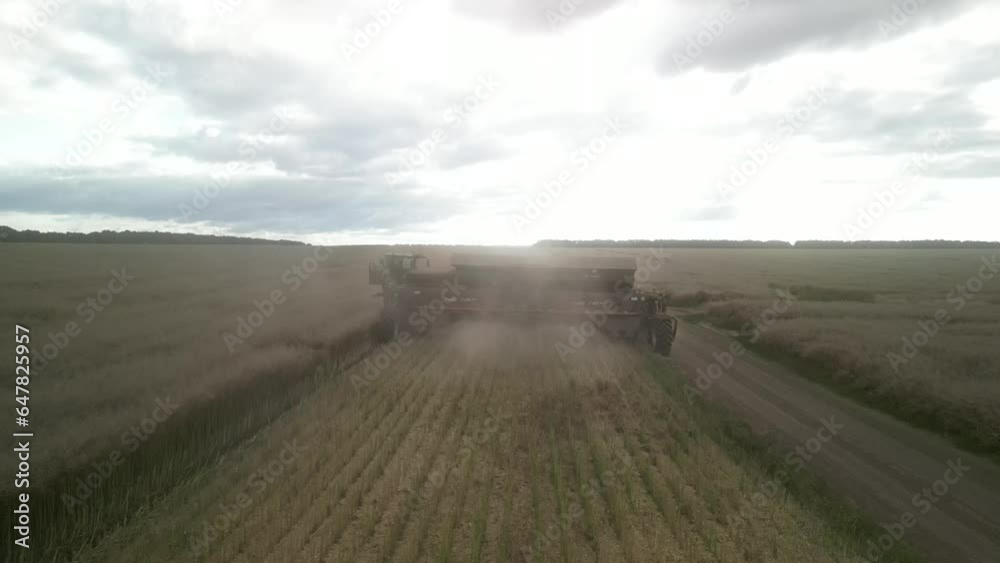 Modern Combine Harvester at canola harvest in Ukraine Modern Combine Harvester at canola harvest in Ukraine