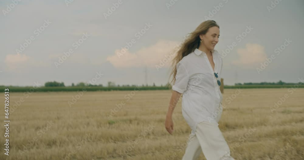 Smiling Young Woman Wearing Shirt Walking In Field