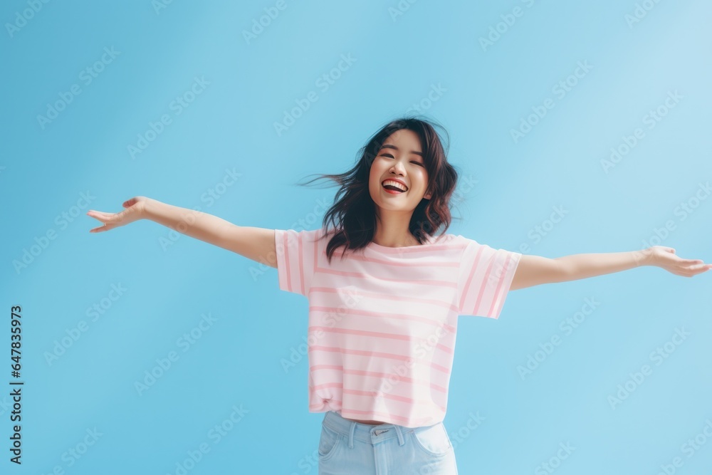 a young woman dancing and raising her hands. a young woman dancing and raising her hands.
