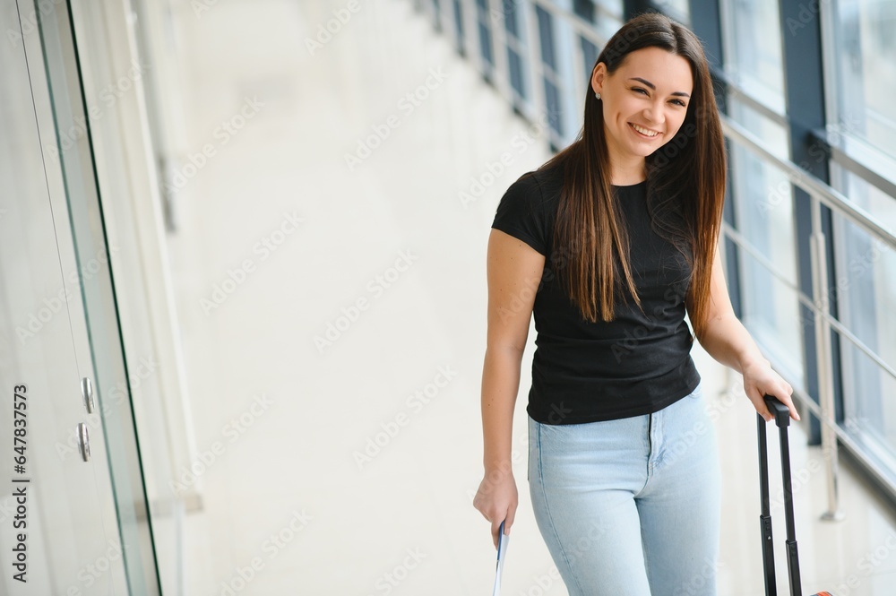 Cheerful attractive young woman travelling by world.
