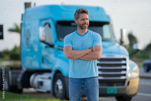 Men driver near lorry truck. Man owner truck . Serious middle aged man trucker trucking owner. Transportation industry vehicles. Handsome man driver front of truck.