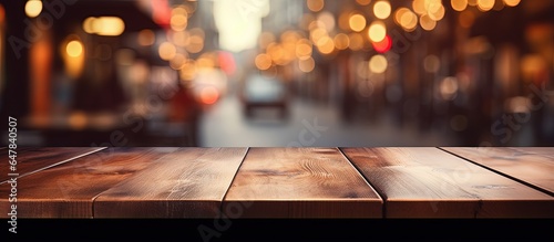 Empty brown wooden table and blurred background with bokeh image suitable for photomontage or product display