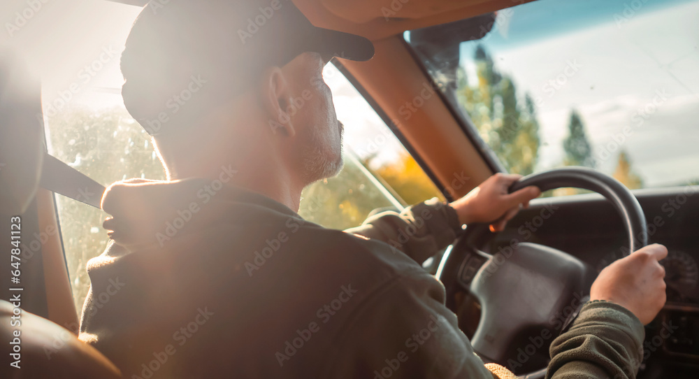 custom made wallpaper toronto digitalA man is driving his car on the road at sunset.