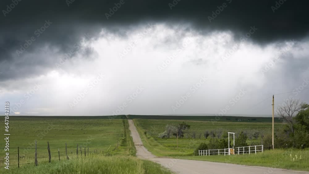 Country Road And Rolling Hills As Dark Textured Clouds Move Over Head Country Road And Rolling Hills As Dark Textured Clouds Move Over Head
