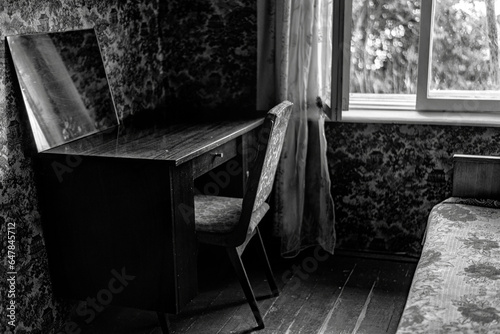Work table in an old house near the window, black and white