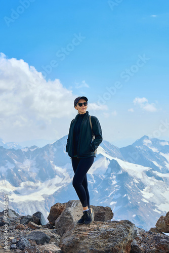 girl on top of snow-capped mountains