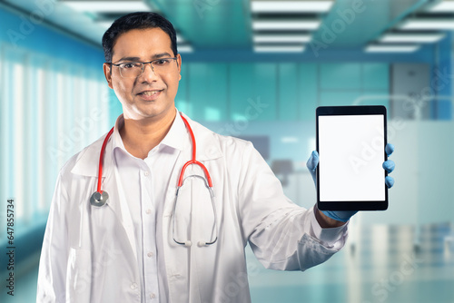 Man doctor with tablet. Moc...