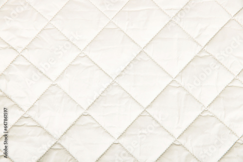 Quilted fabric background. texture blanket or puffer jacket photo