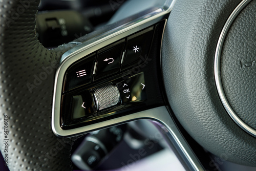 touch and mechanical control buttons for car assistants on the steering wheel © AvokadoStudio