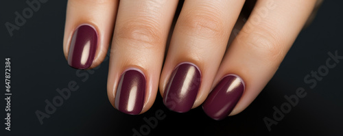 A stunning matte burgundy shade, complemented by a metallic gold accent nail, exuding sophistication and glamour.