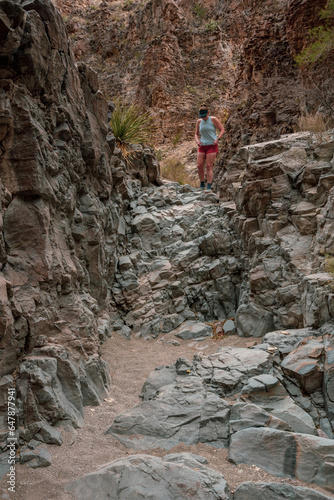 Hiker Climbs Down Small Dry Fall In Big Bend