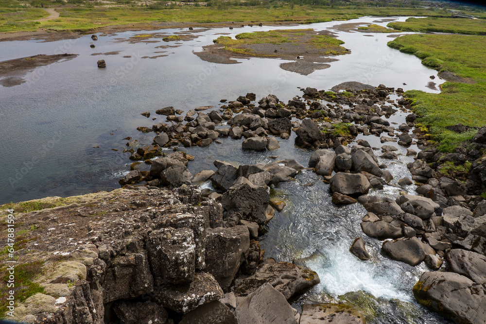 Thingvellir National Park, Rocks in the river Oxara over the Almannagjá. The base of the waterfall Öxarárfoss Waterfall fall is filled with rocks as seen here.