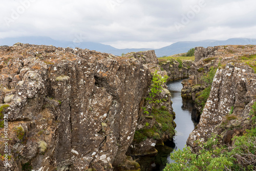 Thingvellir National Park, Rocks in the river Oxara over the Almannagjá. The base of the waterfall Öxarárfoss Waterfall fall is filled with rocks as seen here.  photo