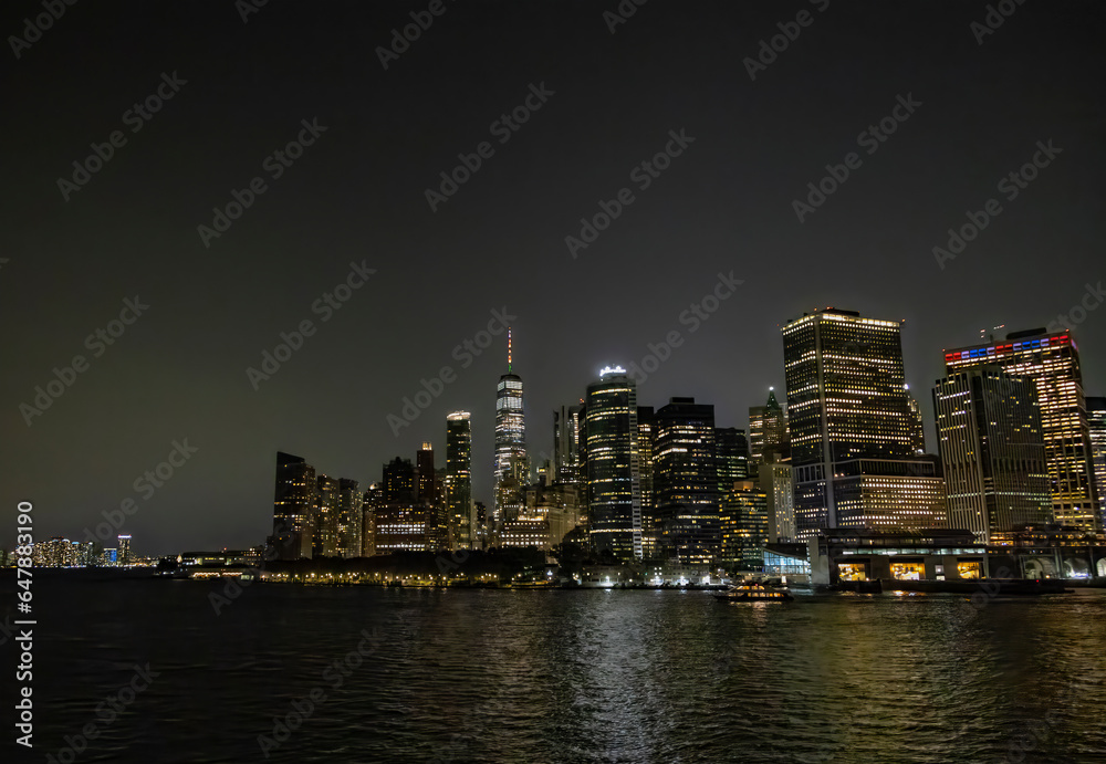 A view of the New York City Skyline as seen from the Staten Island Ferry at night.