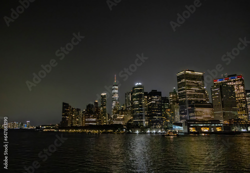 A view of the New York City Skyline as seen from the Staten Island Ferry at night. © John