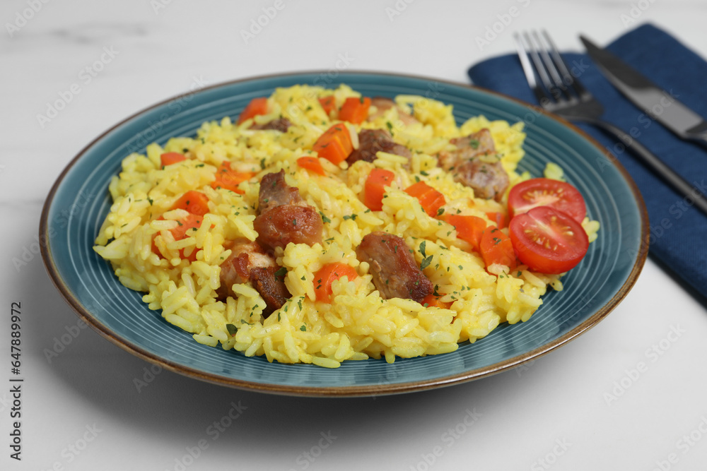 Delicious pilaf with meat served on white marble table, closeup Delicious pilaf with meat served on white marble table, closeup
