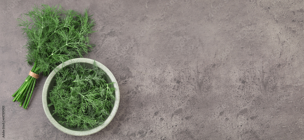 Fresh dill on grey table, top view. Banner design with space for text - obrazy, fototapety, plakaty 