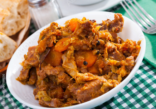 Tasty stew of cabbage with boneless pork and sliced carrots..