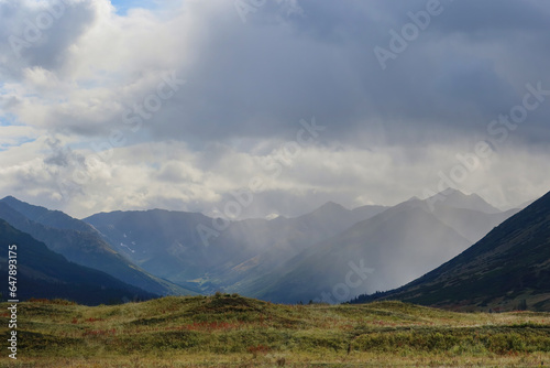 Rain clouds over a glacial valley and mountains in Alaska.