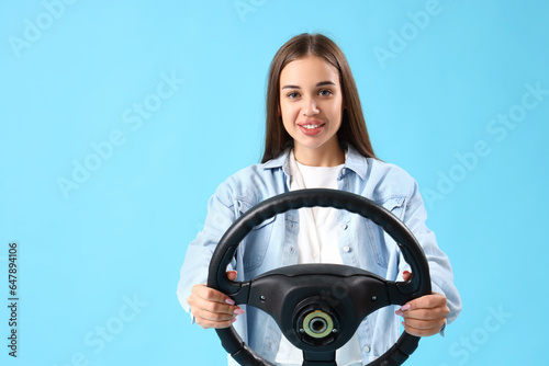 Young woman with steering w...
