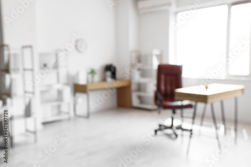 Blurred view of modern light office with comfortable workplace © Pixel-Shot