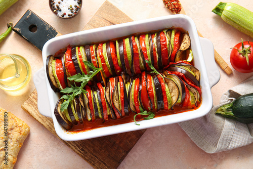 Baking dish of tasty Ratatouille on beige background photo